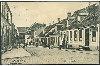Brostræde i Saxkøbing. Central Cafe ved R. Rasmussen til højre. Julius Lund no. 14421. Med skader. 