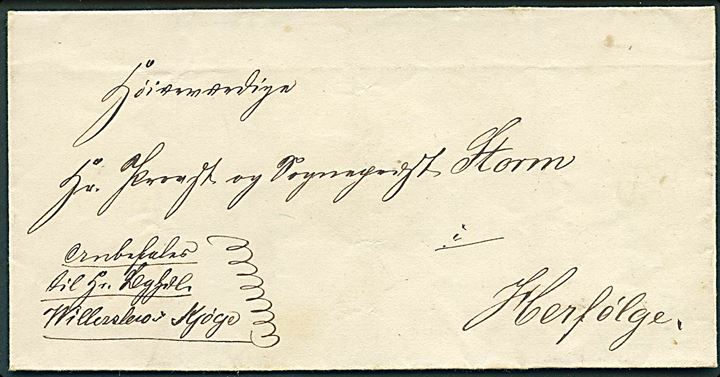 1860 (ca.). Privatbefordret brev fra Vallø til Provst og Sognepræst Storm i Herfølge påskrevet: Anbefaler til hr. Boghdl. Willerslev i Kjøge. Provst Storm blev sognepræst i Herfølge i 1858.