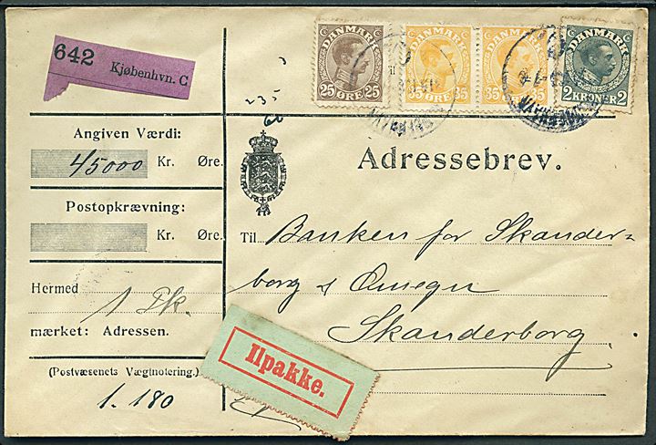 25 øre (kort hj.tak), 35 øre (par) og 2 kr. Chr. X på 295 øre frankeret adressebrev for værdipakke (45.000 kr.) sendt som ilpakke fra Kjøbenhavn d. 31.5.1916 til Skanderborg.