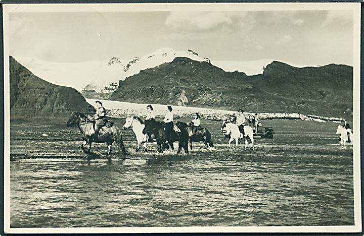Island. Crossing a glacial river on ponies. In the background id the glacier  Ôraefajökull. Photo Thorv R. Jónsson u/no. 