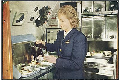 SAS DC-6 Cloudmaster, stewardesse i tilbereder forplejning. Reklamekort u/no.