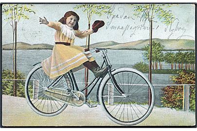 Pige iført lysegul kjole sidder på damecykel. No. 1888. 