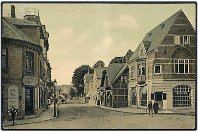 Lyngby, gadeparti med Banken, M.H. Hjuls kaffehandel mm. G.M. no. 2153.