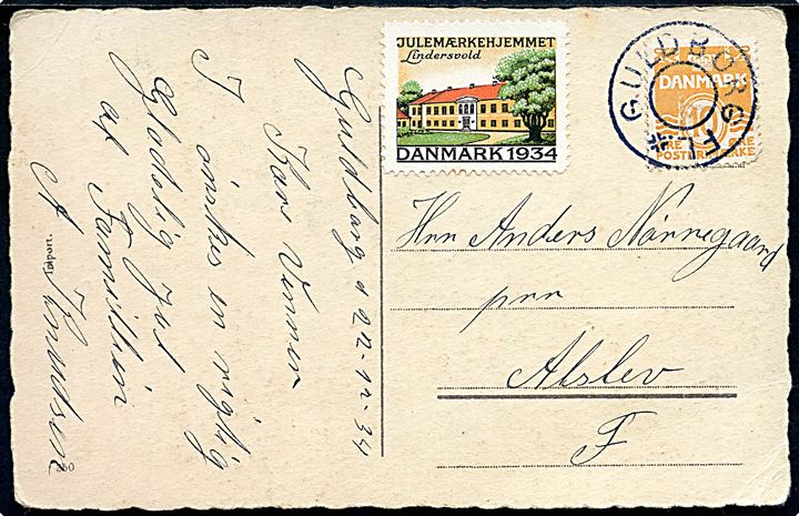 10 øre Bølgelinie (kort hj.tak) og Julemærke 1934 på julekort dateret d. 22.12.1934 annulleret med udslebet stjernestempel GULDBORG FL. til Alslev.
