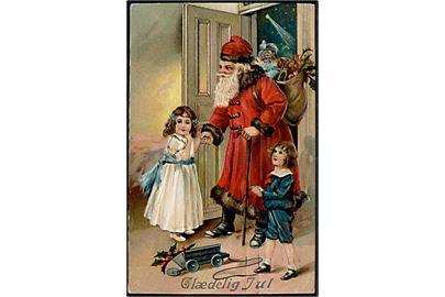 Julemand i rød kåbe kommer med julegaver. EAS no. 16475.