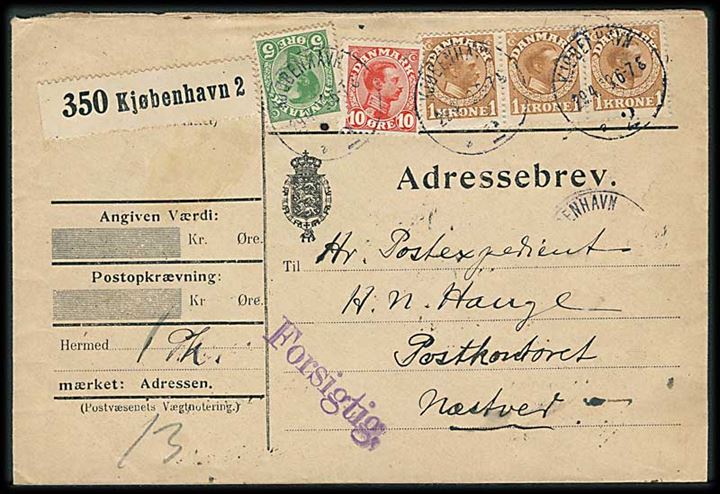 5 øre, 10 øre og 1 kr. (3-stribe) Chr. X på adressebrev for pakke mærket Forsigtig fra Kjøbenhavn d. 29.4.1919 til Næstved.