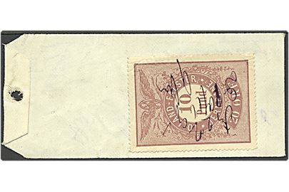 20 øre Lolland-Falster Jernbane 10 punds fragtmærke med blækannullering d. 10.11.1892 (?) på bagsiden af “Manilla”-seddel for pakke fra Rødby til Eskildstrup Station. 