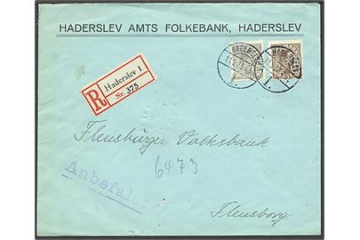 20 og 50 øre Chr. X på anbefalet udlandsbrev sendt fra Haderslev d. 11.5.1923 til Flensburg, Tyskland. Mærkerne firmaperforeret “H.A.F.” Haderslev Amts Folkebank.