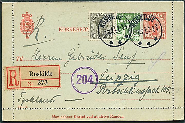 10 øre Chr. X helsags korrespondancekort (fabr. 32-I) med fuld rand opfrankeret med 10 øre Bølgelinie og 50 øre Chr. X sendt anbefalet fra Roskilde d. 7.12.1921 til Leipzig, Tyskland.