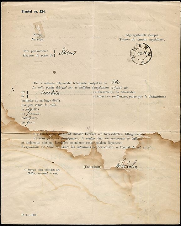 Forespørgsel - Blanket no. 224 - fra Skien d. 8.12.1899 på ubesørgelig pakke fra Aarhus til Norge. Returneret med ny afsender erklæring og påtegning fra både Aarhus Postkontor og Kjøbenhavns Pakkepostkontor. Skjoldet, 