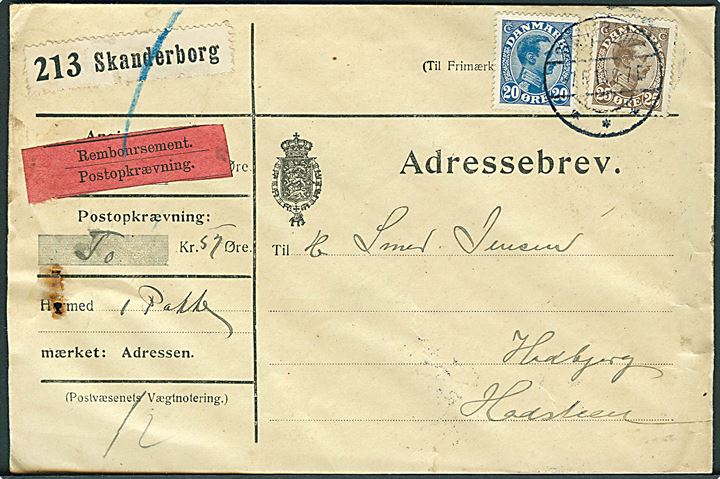 20 øre og 25 øre Chr. X på adressebrev for pakke med opkrævning fra Skanderborg d. 7.6.1918 til Hadsten. Fugt i venstre side.